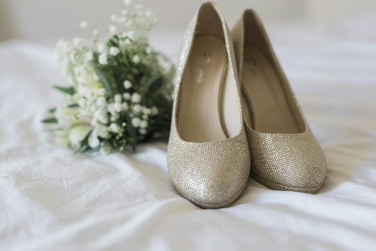 Beautiful golden bridal shoes paired with a delicate white bouquet, perfect for wedding style inspiration.