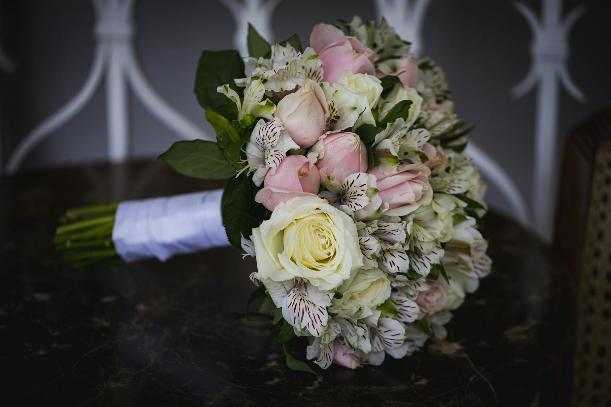 Beautifully arranged bridal bouquet featuring pink roses, white roses, and alstroemeria flowers, perfect for weddings.