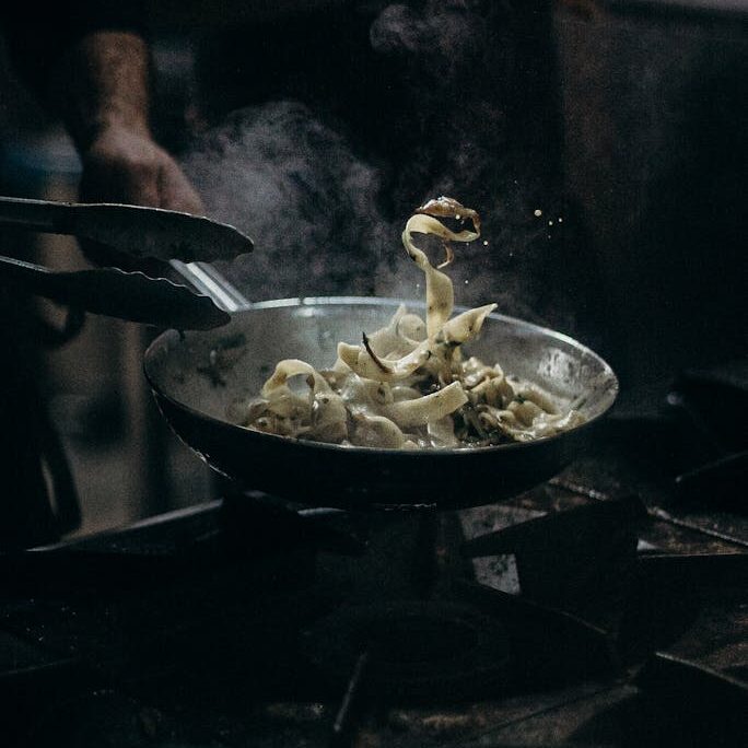 Person Cooking on Black Pan
