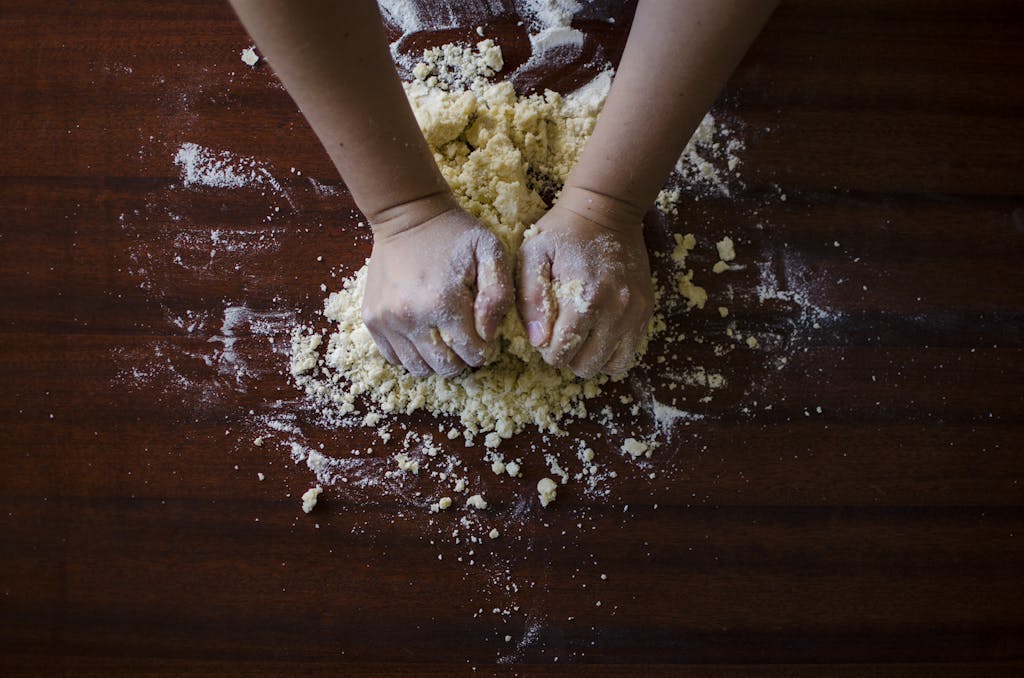 Person Mixing Dough