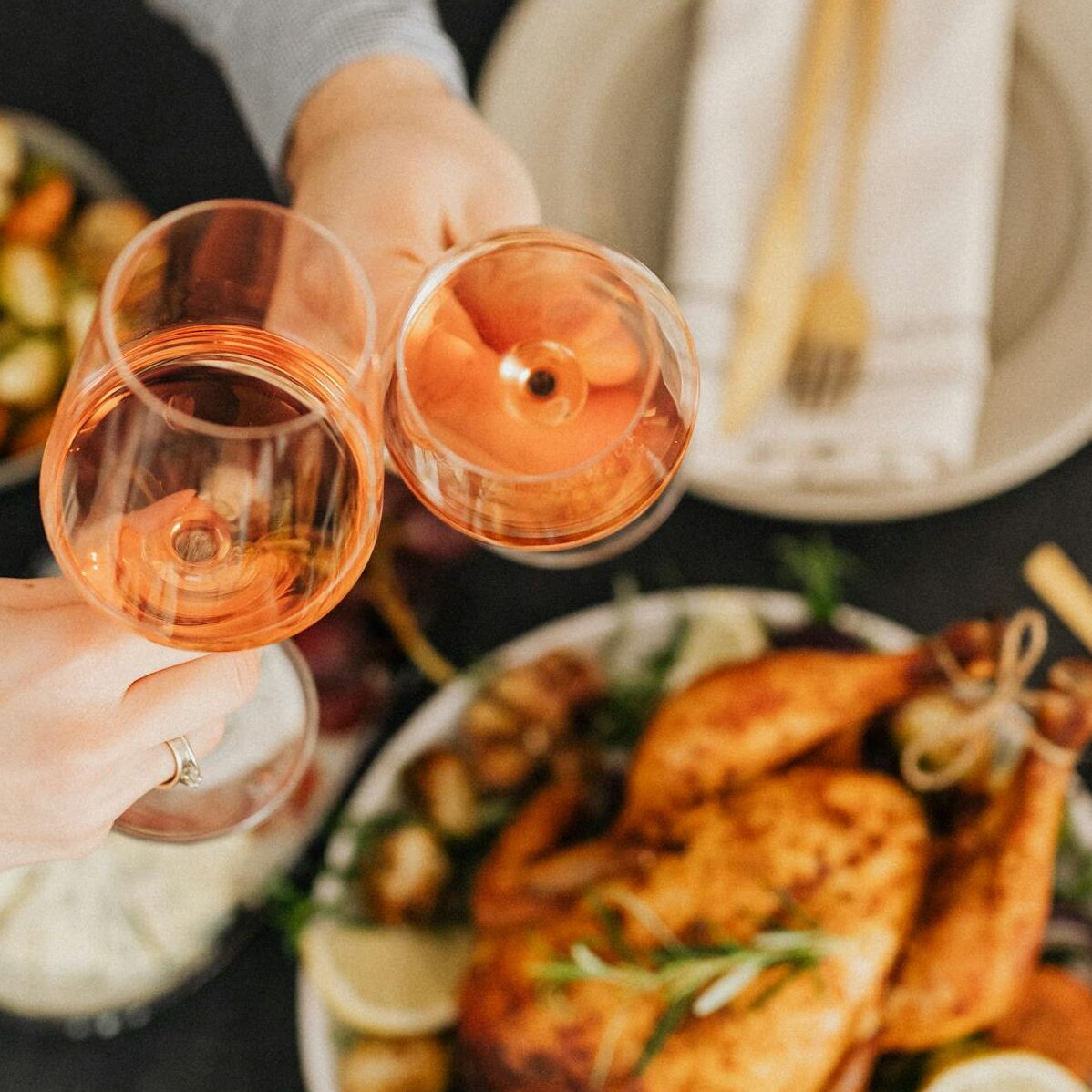 Food On The Table With Two People Having Wine