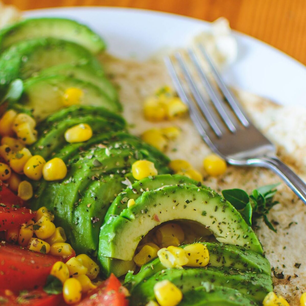 Sliced Tomato and Avocado on White Plate