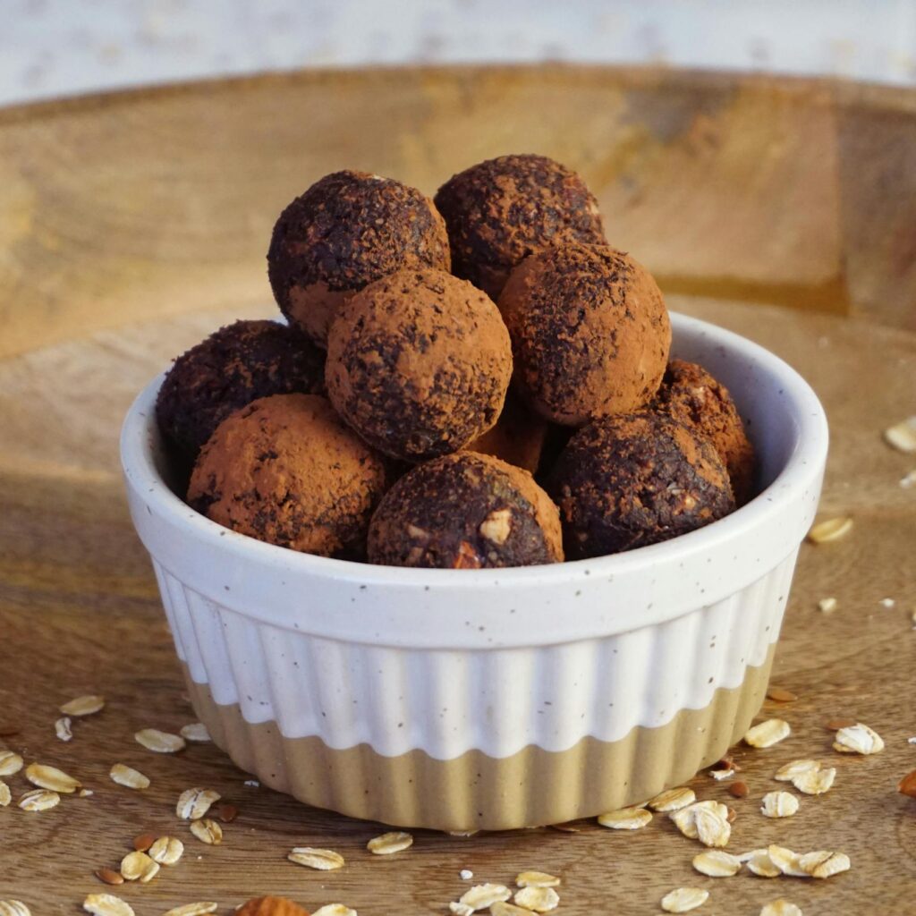 A bowl of homemade vegan chocolate energy bites made with natural ingredients for a guilt-free snack.