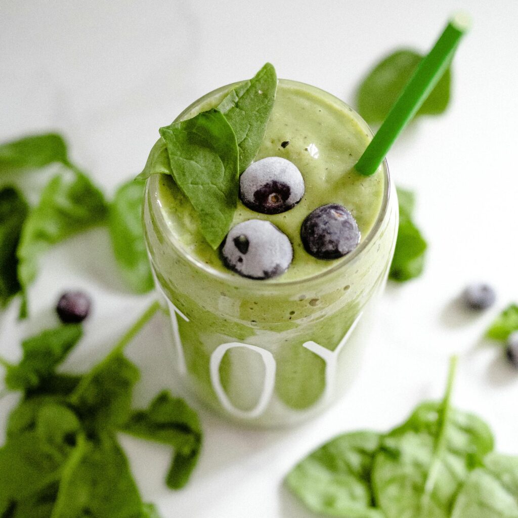 Invigorating green smoothie with spinach and blueberries, perfect for a healthy boost.