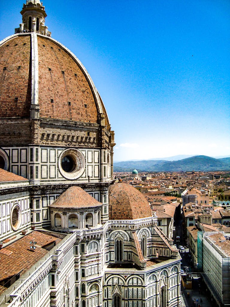 Iconic view of Florence Cathedral's dome against a clear Tuscan sky, a masterpiece of Renaissance architecture. Photo by Maegan White