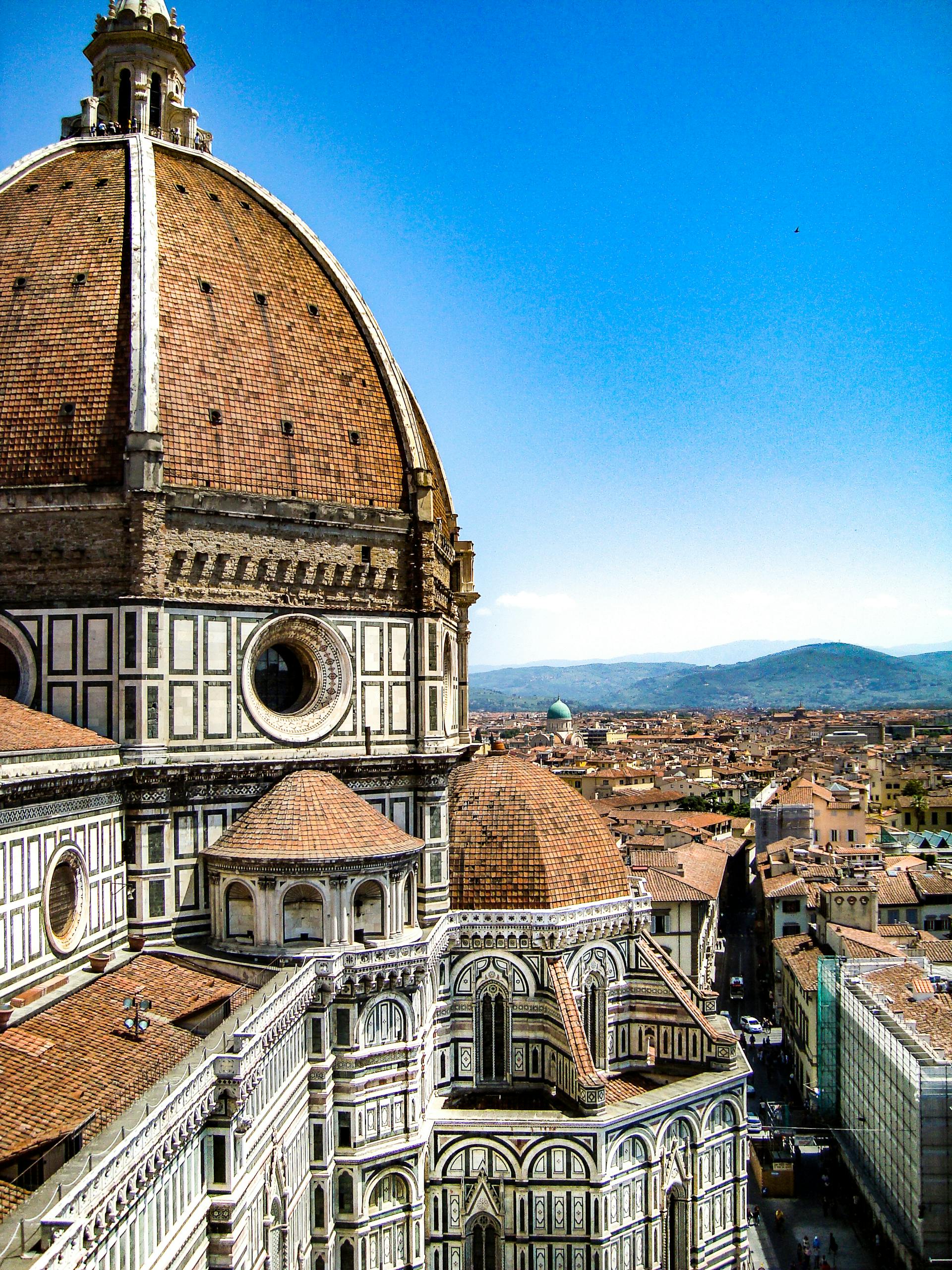Iconic view of Florence Cathedral's dome against a clear Tuscan sky, a masterpiece of Renaissance architecture. Photo by Maegan White