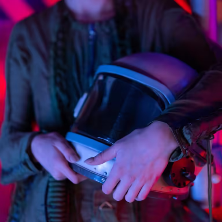 Person In Spacesuit Holding A Helmet