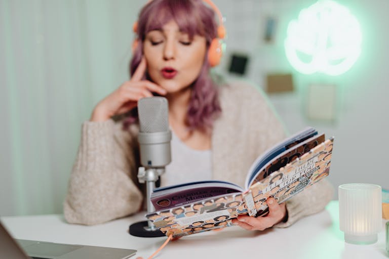 Woman in Brown Sweater Holding a Book