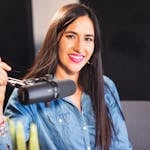 Woman Smiling Next to a Microphone