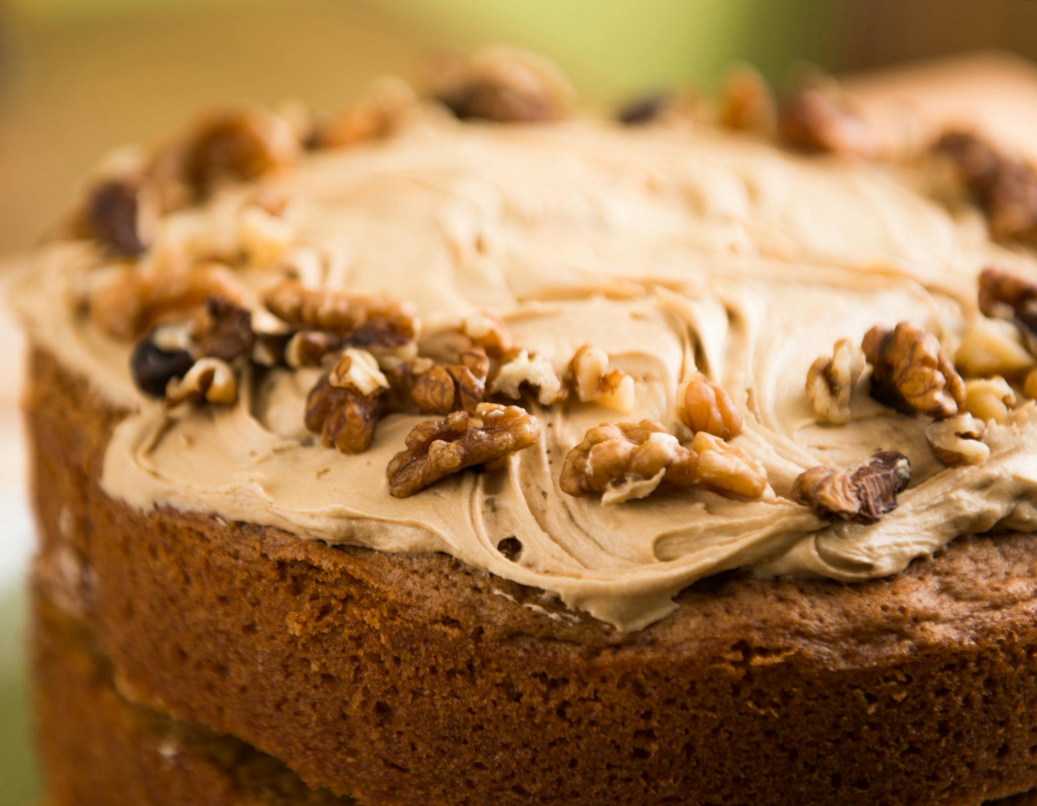 Closeup of a homemade walnut cake with creamy frosting, perfect for dessert lovers.