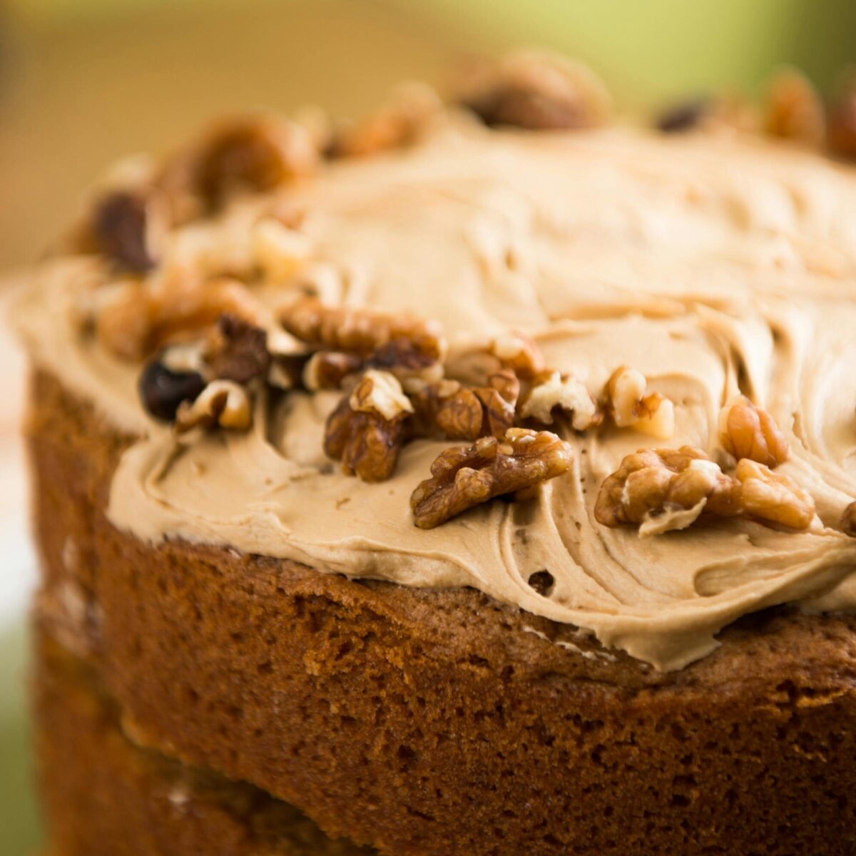 Closeup of a homemade walnut cake with creamy frosting, perfect for dessert lovers.