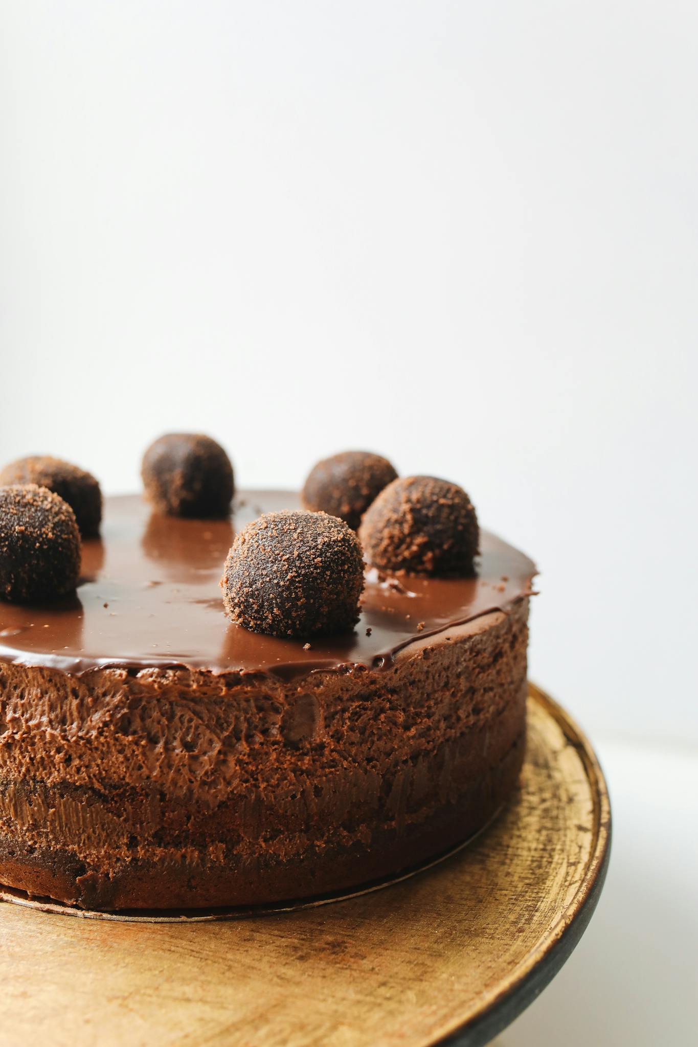 Indulge in a rich chocolate mousse cake topped with truffles, perfect for dessert lovers.