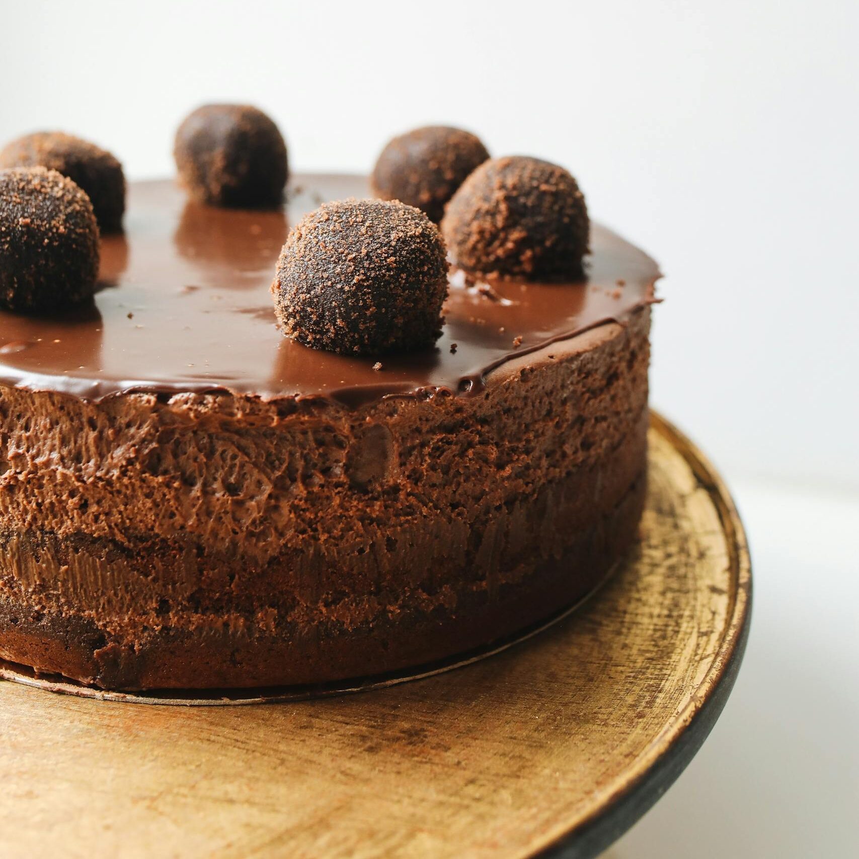 Indulge in a rich chocolate mousse cake topped with truffles, perfect for dessert lovers.
