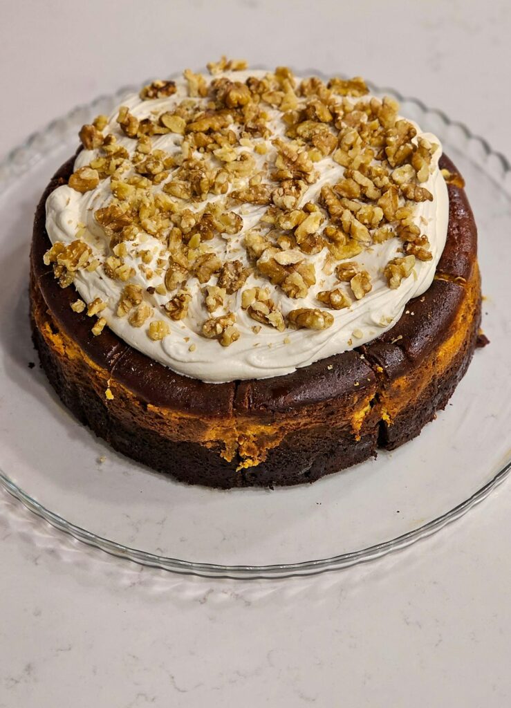 Mouthwatering homemade cake topped with creamy frosting and walnuts.