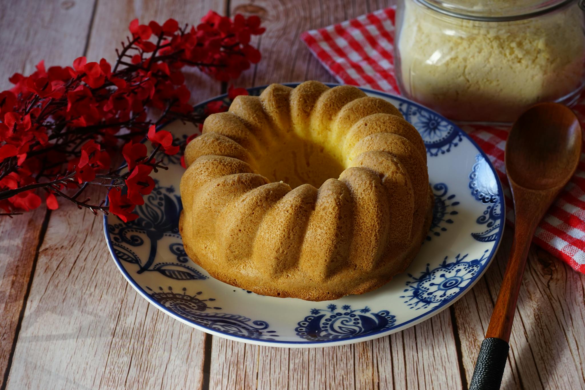 Rustic homemade bundt cake served on a ceramic plate with a wooden background.
