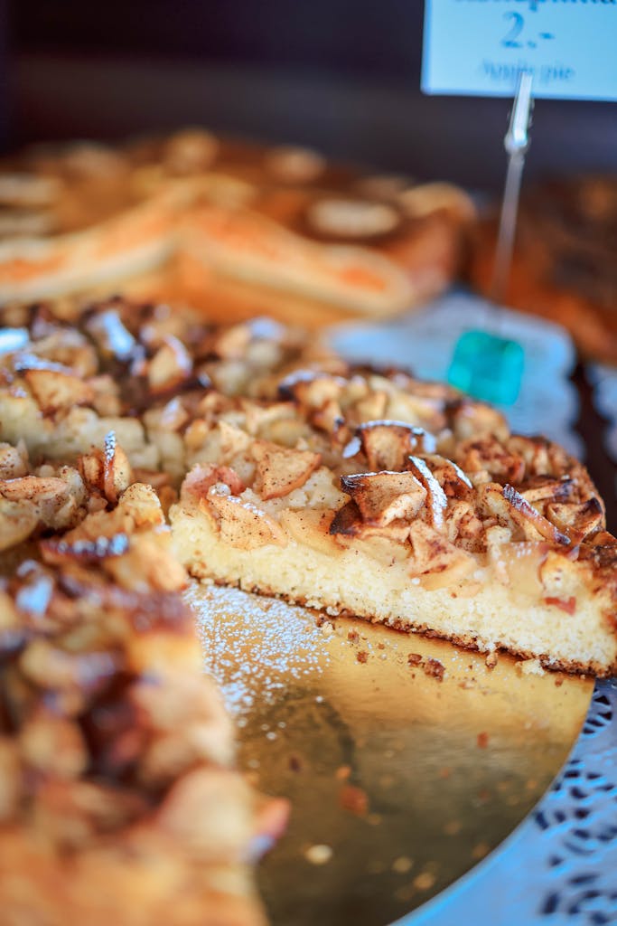 Warm and inviting apple cake slice dusted with powdered sugar, showcasing a homemade dessert.