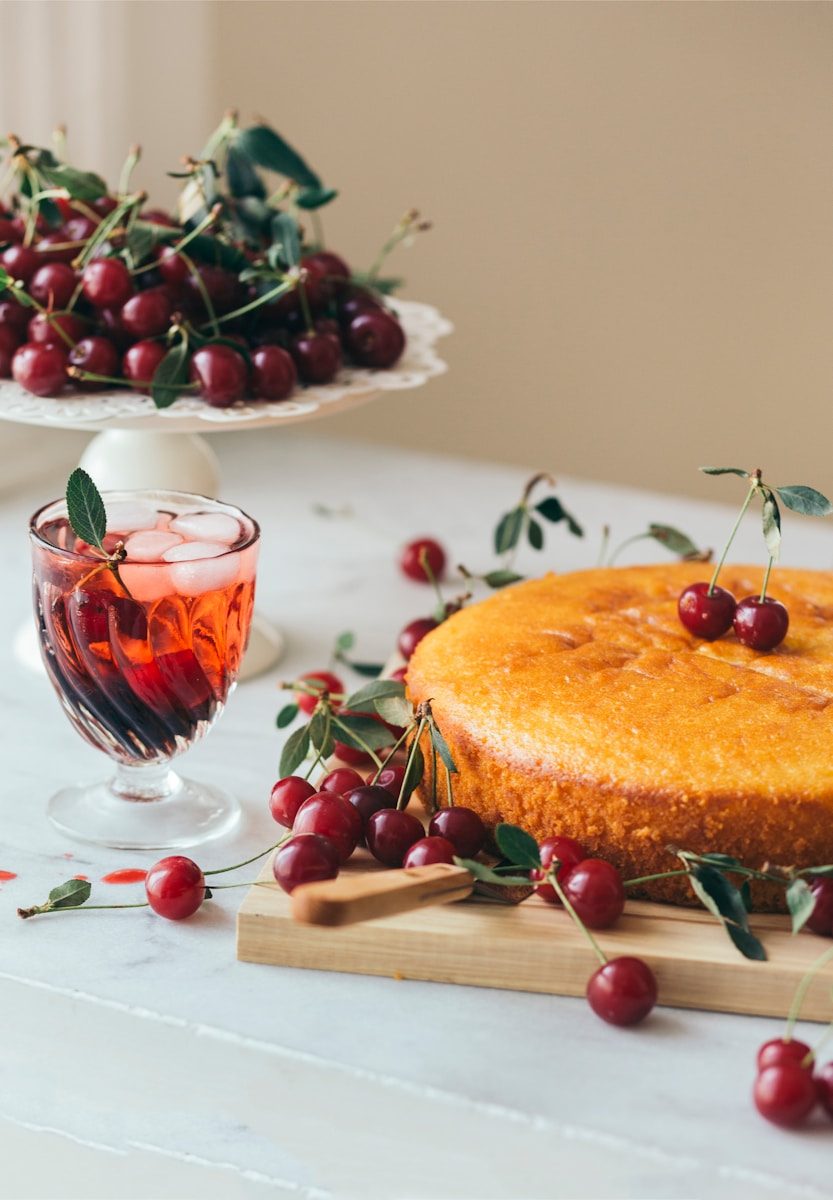 a cake and a glass of wine on a table