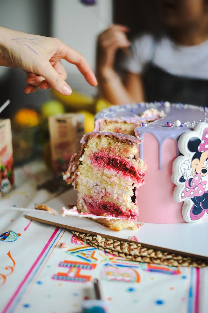 Exciting birthday cake with Minnie Mouse decoration, perfect for a kids' party.