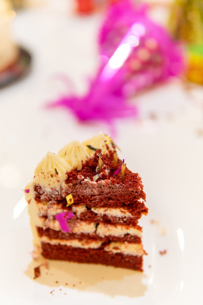 Delicious red velvet cake slice adorned with creamy frosting, perfect for festive occasions.